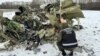 An investigator examines debris at the crash site of an Ilyushin Il-76 aircraft, which came down near the western Russian city of Belgorod on January 24.