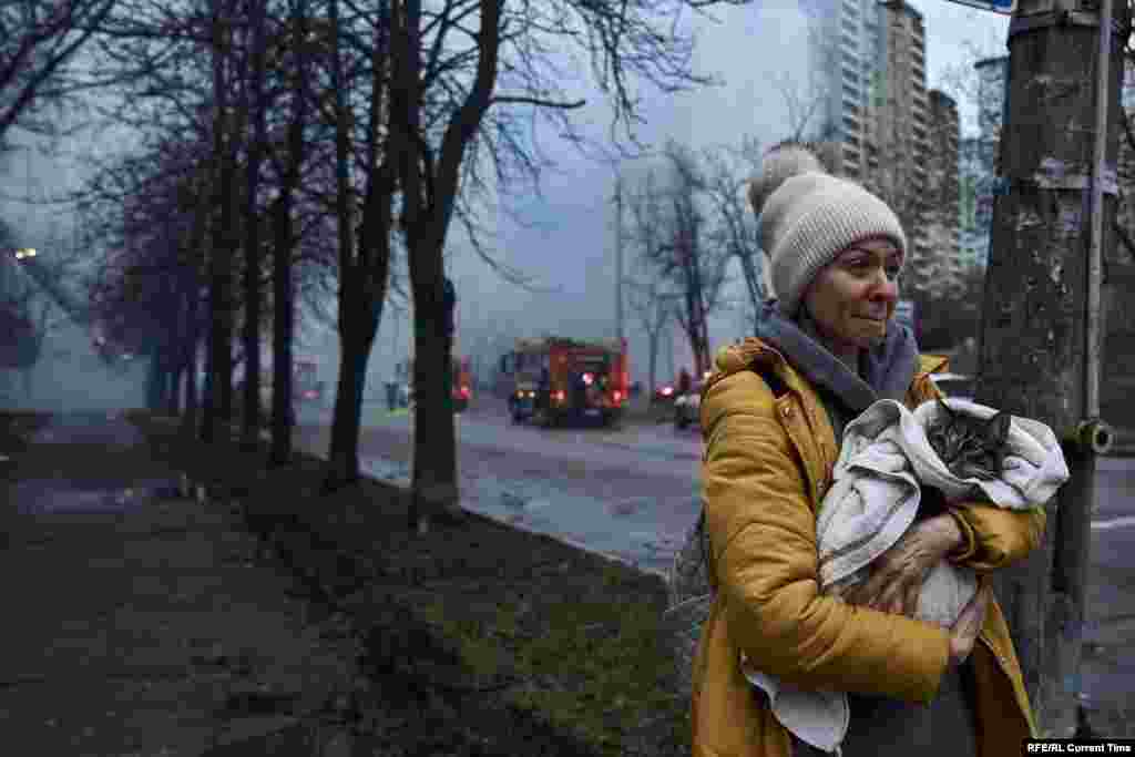 Женщина спасает кота из разрушенного дома, по которому ударила российская пакета, 2 января 2024 года. 