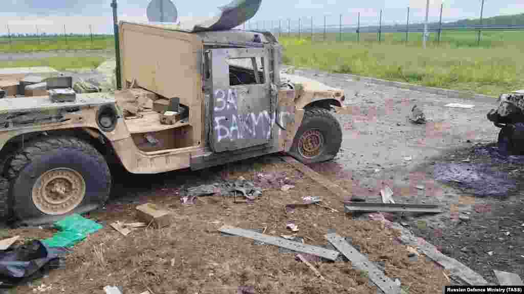 A damaged vehicle with "For Bakhmut" spray-painted on its door is seen in a video grab from footage believed to have been taken inside Russia on May 23.  The raid into Belgorod was reportedly launched by the Russian Volunteer Corps and the Free Russia Legion. Both groups are made up of ethnic Russians who have fought alongside the Ukrainian military against the Russian invasion.