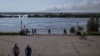 Smoke over the flooding Dnieper River can be seen from the elevation of Kherson's Glory Park.