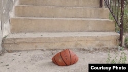 A slashed basketball lying on the doorstep of Nedim Salaharevic's family home in the village of Vlasenica. He says it is "a clear message" sent to intimidate him due to his providing testimony at war crimes trials.