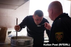 Andriy Talanov and Viktor Veretelnyk sample the okroshka they are making during downtown at Kharkiv's main fire station.