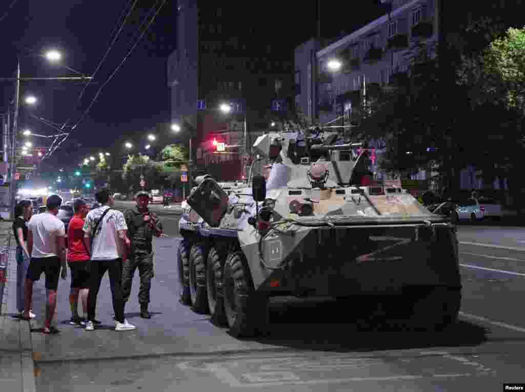 An image made before dawn on June 24 showing civilians in Rostov-on-Don gathered around an armored vehicle marked with the letter Z associated with Russia's invasion of Ukraine. 