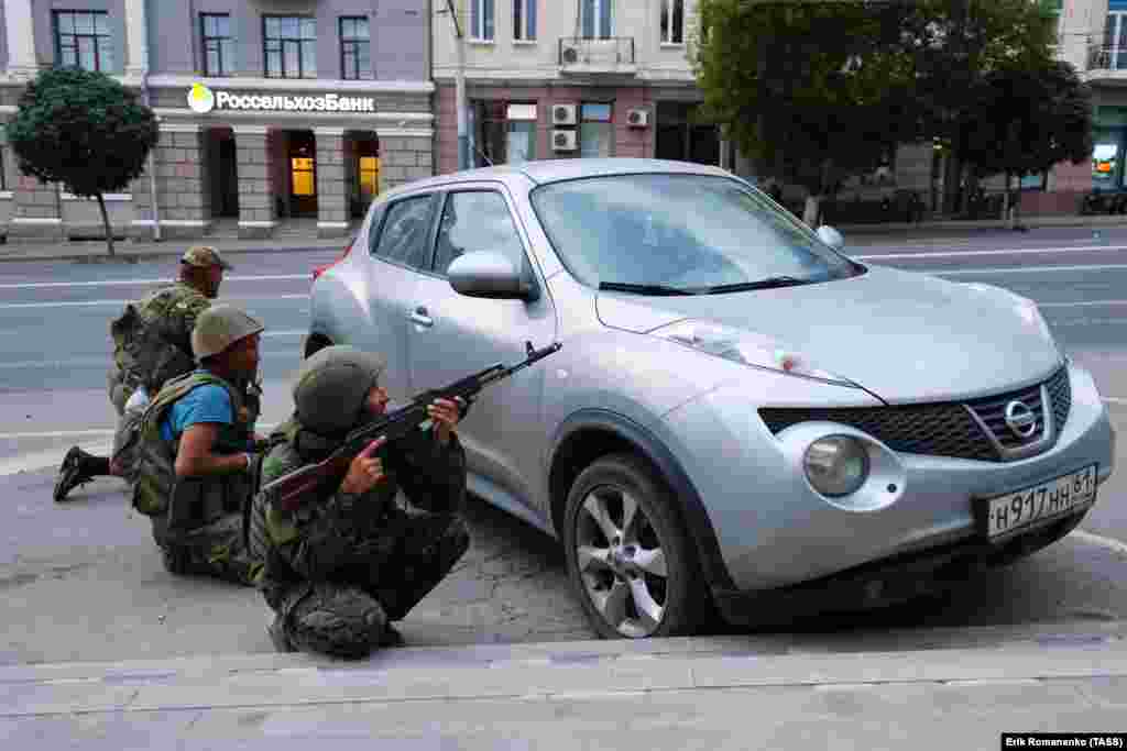 Men reportedly with the Wagner group take up positions behind a civilian car.  Russia’s Federal Security Service announced a criminal case against Prigozhin for “incitement to armed rebellion” after he vowed to lead a “march of justice” against top officials in Russia’s Defense Ministry.