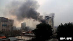 Smoke billows from a Chinese-owned hotel in Kabul following a bomb attack in the Afghan capital on December 12.
