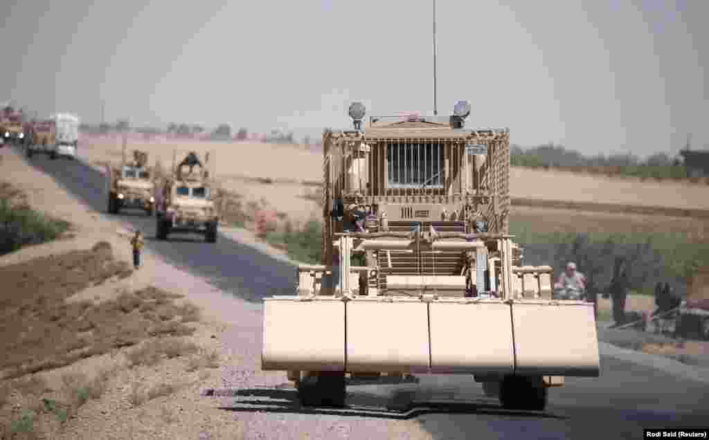 A U.S military demining vehicle leads a convoy near Raqqa in July 2017. 