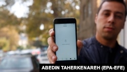 A man in Tehran shows his phone while unable to load a social-media page amid an Internet shutdown in Iran.