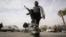 SYRIA – An opposition fighter steps on a broken bust of the late Syrian President Hafez Assad in Damascus, Syria, Dec. 8, 2024