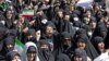 Iranians wave the national flag as they take part in a state-sponsored rally in Tehran on September 23. 