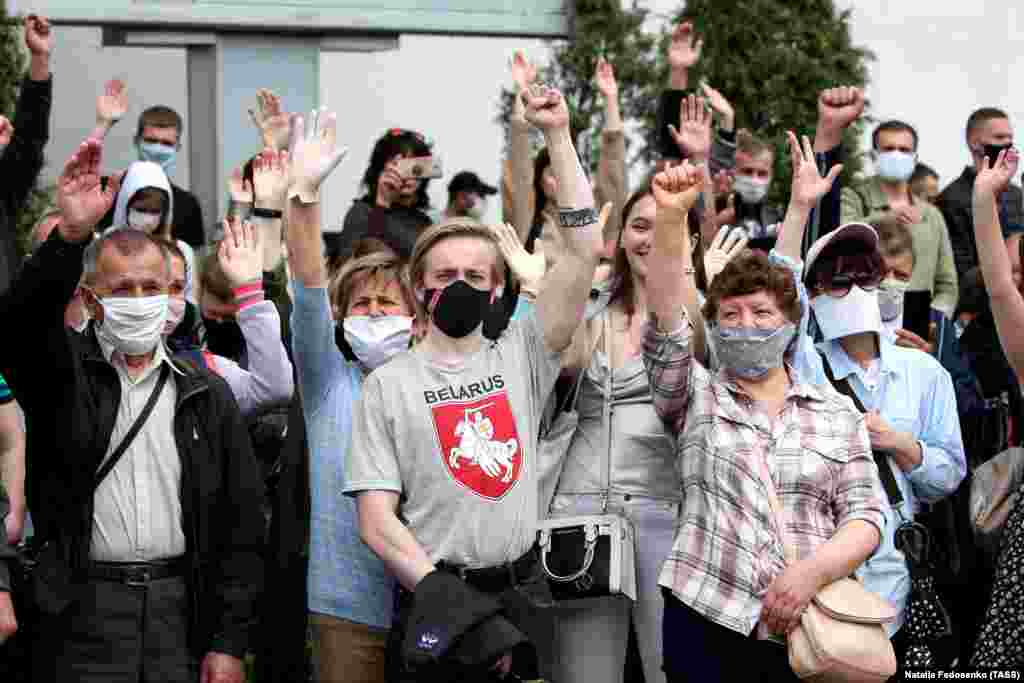 People in face masks attend a rally near the Komarovka Market in Minsk on June 7. The rally was organized by activists to collect signatures in support of opposition presidential hopefuls.     