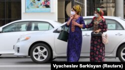 Women wear face masks as a preventive measure against the spread of COVID-19 in Ashgabat despite claims by the Turkmen government that the virus does not exist there.