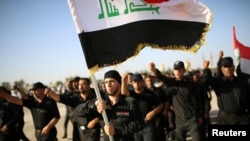 Fighters loyal to Shi'ite cleric Muqtada al-Sadr march during a military-style training drill in the holy city of Najaf.