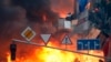 PHOTO GALLERY: Buildings, tents, and barricades burned on Kyiv's Independence Square after a day and night of clashes that left at least 25 people dead. 