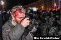 Garanich at work after being hit by a policeman in Kyiv.