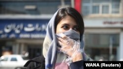 An Iranian woman in Iran covers her face amid a coronavirus outbreak in the Middle Eastern Country.