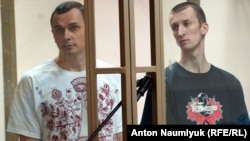 Ukrainian filmmaker Oleh Sentsov (left) and his co-defendant Oleksandr Kolchenko on trial in a Russian court in 2015.