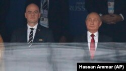 Russian President Vladimir Putin (right) attends the opening match of the soccer World Cup with FIFA President Gianni Infantino.