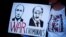 Изображения Владимира Путина и Александра Лукашенко с надписью "Военные преступники". Плакат на акции протеста против российского вторжения в Украину. Лондон, 26 марта 2022 года