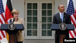U.S. President Barack Obama (right) and German Chancellor Angela Merkel address a joint news conference in the Rose Garden of the White House in Washington on May 2.