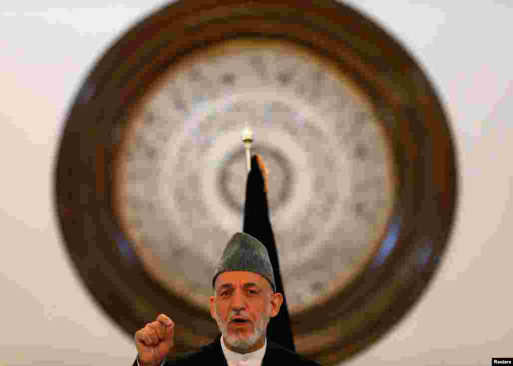 Karzai gives a farewell speech during a gathering of government employees in Kabul on September 23, 2014. Karzai blamed the United States for his country's long war, a final swipe at the country that helped bring him to power 13 years ago but toward which he has become increasingly bitter.