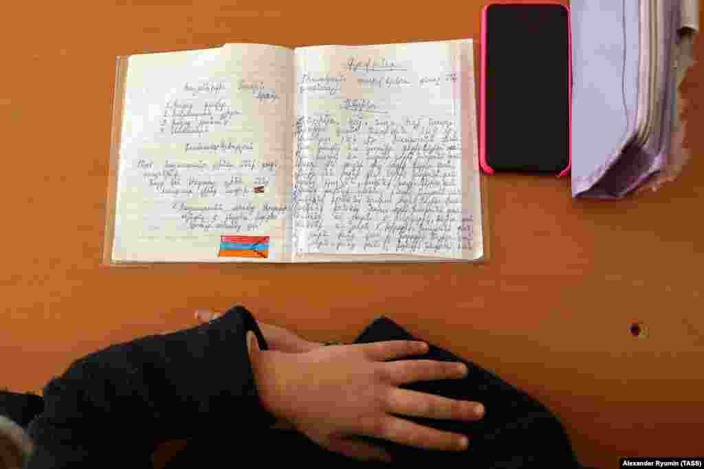 A child's texbook at a school in Stepanakert features a drawing of the separatist Nagorno-Karabakh flag on December 2. 
