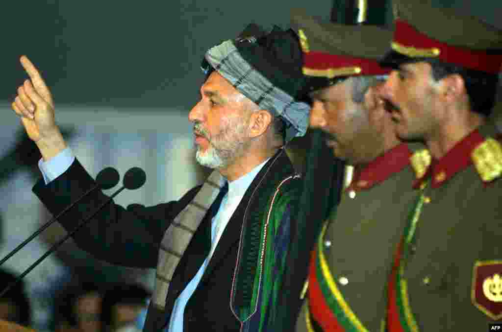Karzai speaks during an emergency Loya Jirga, or grand assembly, in Kabul on June 19, 2002, during which he was chosen for a two-year term as interim president of the Afghan transitional government.