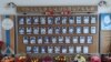 A wall of photos at Taghavard's school showing local fighters killed in the first Nagorno-Karabakh War (1988-94).
