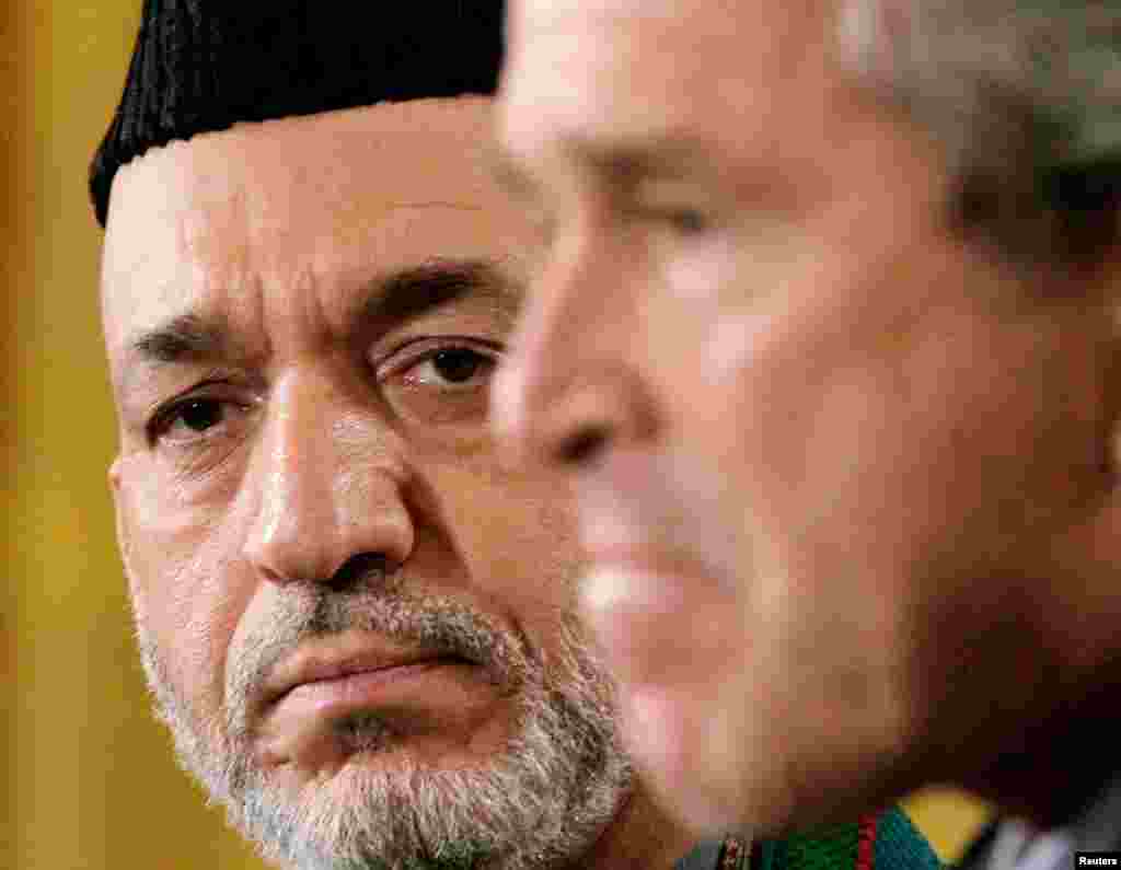 U.S. President George W. Bush holds a joint news conference with Karzai in the East Room of the White House on September 26, 2006.