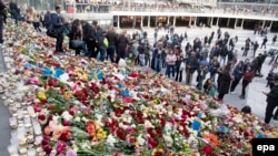 Floral tributes on the steps at the Swedish captial's Sergels Torg square for victims of a truck attack in central Stockholm.