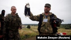 A pro-Russian separatist holds a stuffed toy found at the crash site of Malaysia Airlines Flight MH17 in eastern Ukraine on July 18.