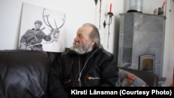 Johannes Halonen with a picture of his father, Klemet Jouni Jeremias Halonen, a Finnish soldier whose picture surprisingly ended up being used for a Russian Victory Day poster.