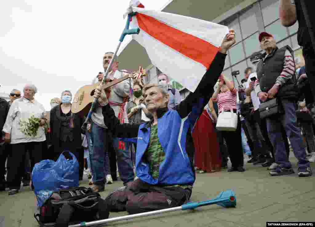 A rally attendee holds a white-red-white flag, which is used by opposition supporters, during the June 7 rally.  