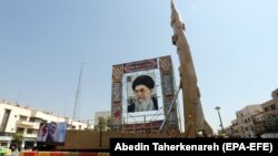 A Shahab-3 surface-to-surface missile, which is said to be capable of delivering a long-range nuclear warhead, is displayed next to a portrait of Iranian Supreme Leader Ayatollah Ali Khamenei at a street exhibition in Tehran earlier this year.