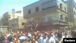Demonstrators march through the streets of Damascus on July 1.