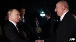 Vladimir Putin (left) is greeted by his Azerbaijani counterpart, Ilham Aliyev, upon the Russian president's arrival in Baku on August 18.