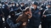 A man is taken away by law enforcement officers during an opposition rally to demand the resignation of Armenian Prime Minister Nikol Pashinian