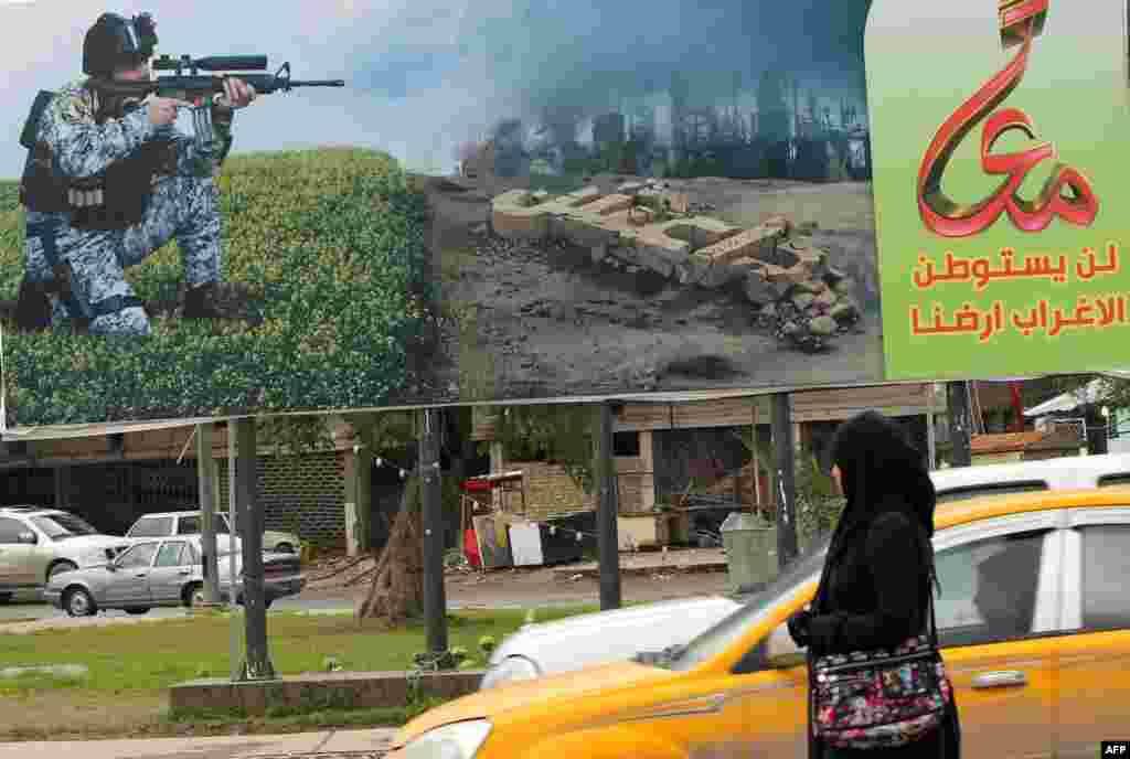 In Baghdad, a billboard depicting a member of the Iraqi security forces aiming his weapon against unseen militants.