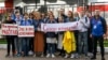 Journalists from the Belarusian Tut.by media outlet hold banners reading "I don't protest but work" (left), "This is me at work" (center), and "Freedom for journalists!" as they stand in front of a police station in Minsk in September 2020. They were protesting the arrest of colleagues who were covering anti-government protests at the time. Tut.by's news website has since been blocked by Belarusian authorities.