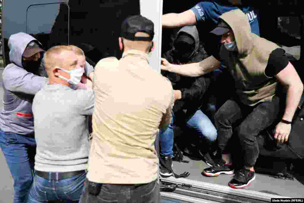 Supporters of Sevyarynets try to prevent the opposition politician from being taken by unknown men.  