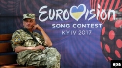 A Ukrainian serviceman rests near the Eurovision Song Contest fan zone on Khreshchatyk Street in downtown Kyiv.
