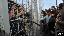 Refugees from Afghanistan protest against the closure of the Greek-Macedonian border near the village of Idomeni on February 22.