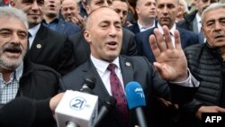 Former Kosovar Prime Minister Ramush Haradinaj (center) speaks to reporters following his release by a French court on April 27.